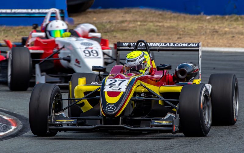 Car 27 leads car 99 in corner during a Formula 3 race at Queensland Raceway